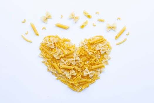 Different types of dry pasta on white background