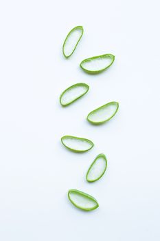 Aloe vera slices on white background.