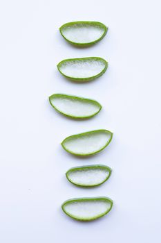 Aloe vera slices on white background.