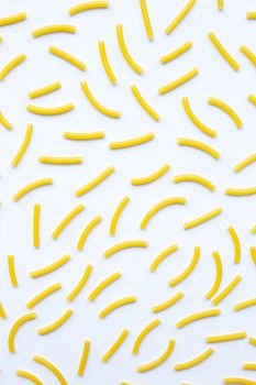 Uncooked macaroni on a white background.