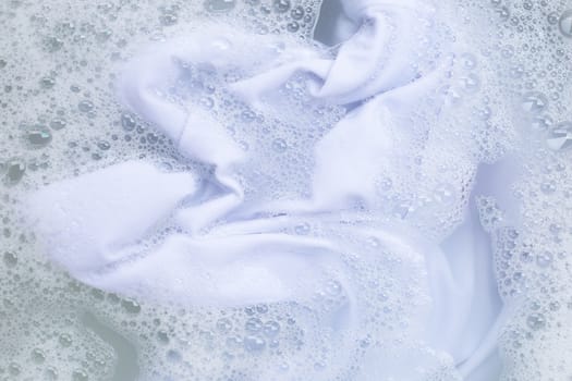 Soak a cloth before washing, white cloth. Top view
