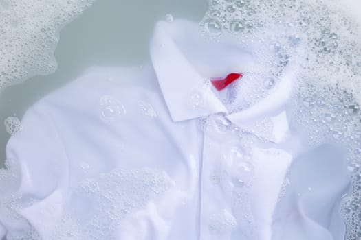 Soak a cloth before washing, white polo shirt. Top view