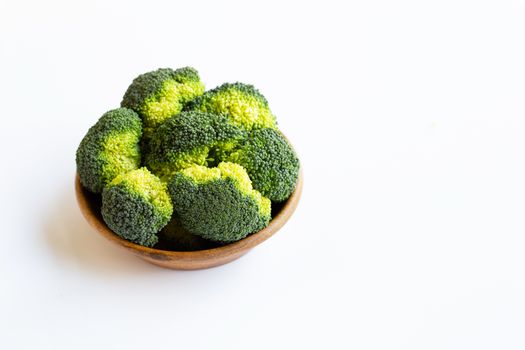 Broccoli in wooden bowl on white background