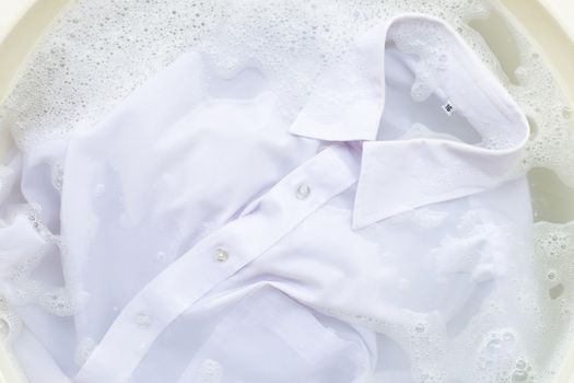 Soak a cloth before washing, white shirt