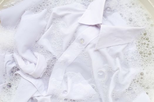 Soak a cloth before washing, white shirt