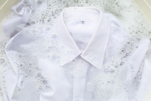 Soak a cloth before washing, white shirt