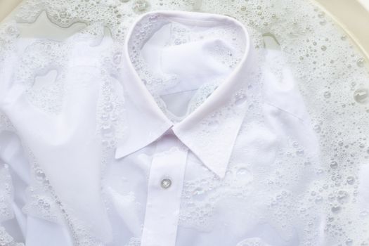 Soak a cloth before washing, white shirt