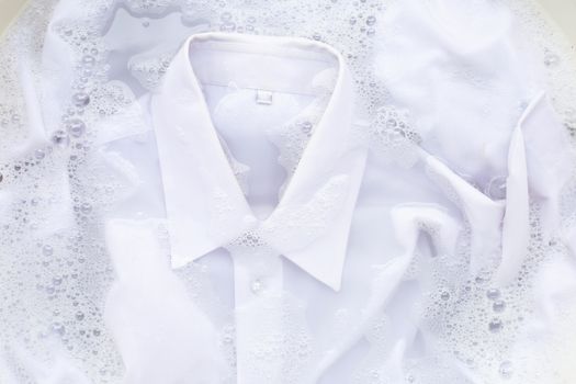 Soak a cloth before washing, white shirt