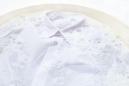 Soak a cloth before washing, white shirt