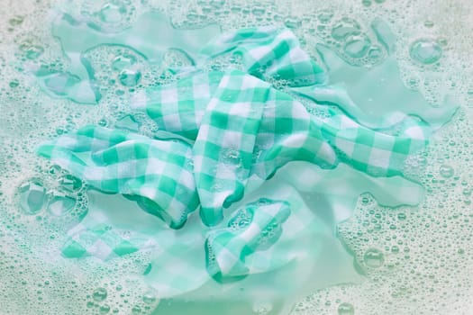 Soak a green white tablecloth before washing.