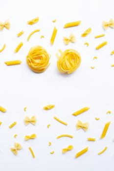 Different types of dry pasta on white background