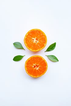 Orange fruits and green leaves on a white background. Top view