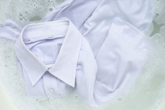 Soak a cloth before washing, white shirt