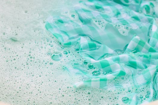 Soak a green white tablecloth before washing.