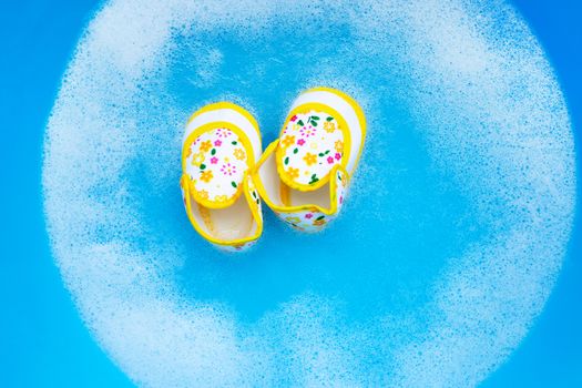 Soak baby shoes in baby laundry detergent water dissolution before washing.  Laundry concept, Top view