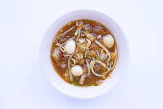 Braised fish maw in red gravy in bowl on white background.