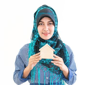 Muslim Woman is holding a house model for housing concept