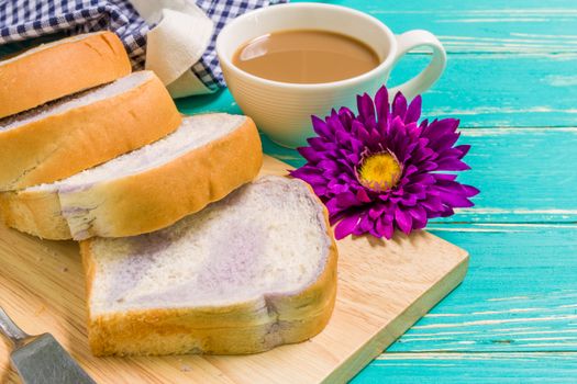 Taro bread with coffee for breakfast on vintage wooden background.