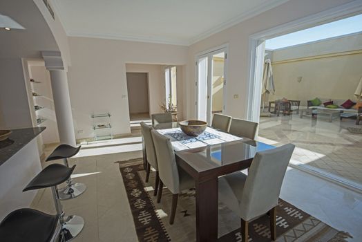 Dining area in luxury villa show home showing interior design decor furnishing with dining table and outdoor patio area