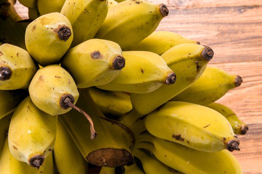 Bunch of ripe banana on wooden background.