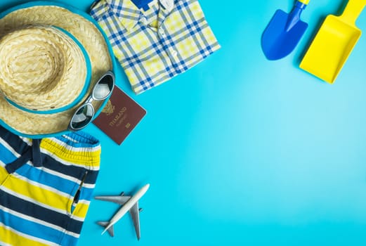 Summer Travel Fashion and toys for boys on blue copy space