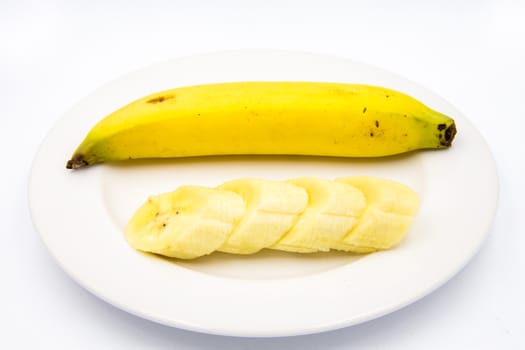 The banana slices were placed on a white plate.