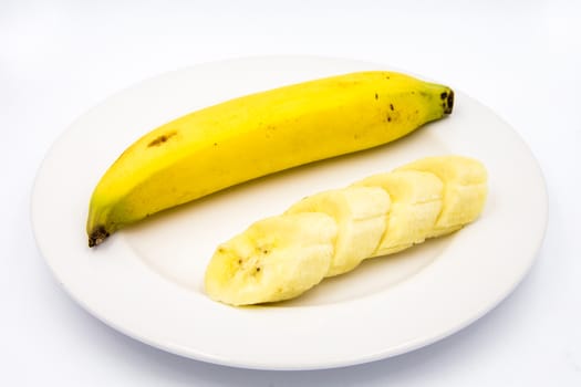 The banana slices were placed on a white plate.