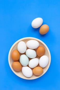 Eggs on blue background. Top view