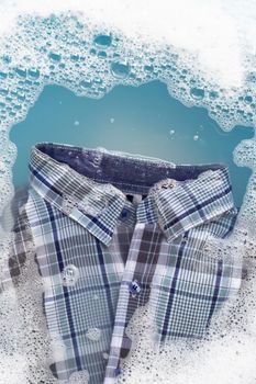 Shirt soak in powder detergent water dissolution, washing cloth. Laundry concept