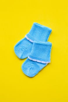 Baby socks on yellow background. Top view