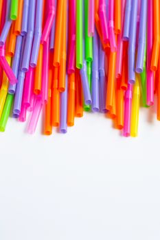 Colorful plastic  straws on white background. Plastic waste pollution.