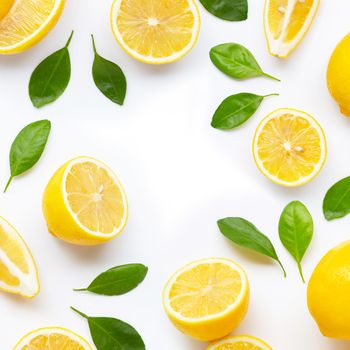 Frame made of fresh lemon and  slices with leaves isolated on white background.