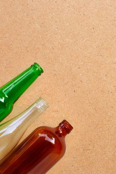 Glass bottles on plywood background. Copy space