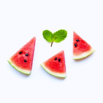 Fresh watermelon slices with mint leaves on white background. Copy space