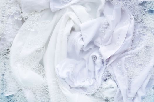 White shirt soak in powder detergent water dissolution, washing  cloth. Laundry concept