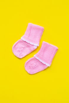 Baby socks on yellow background. Top view