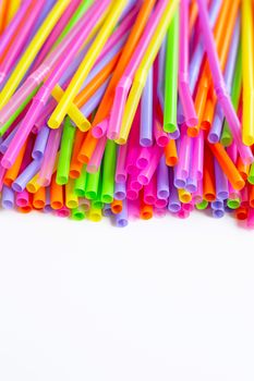 Colorful plastic  straws on white background. Plastic waste pollution.