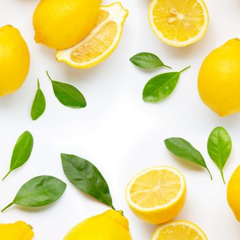 Frame made of fresh lemon and  slices with leaves isolated on white background.