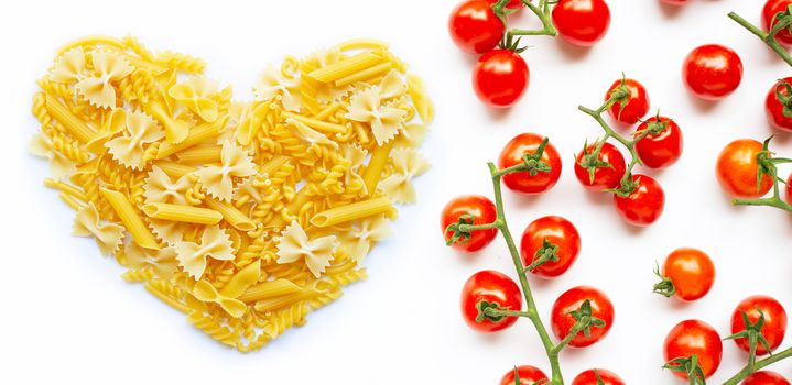 Different types of pasta with cherry tomatoes on white background. Italian food concept