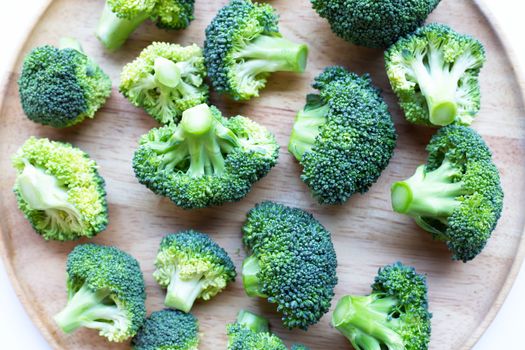 Broccoli on wooden plate background