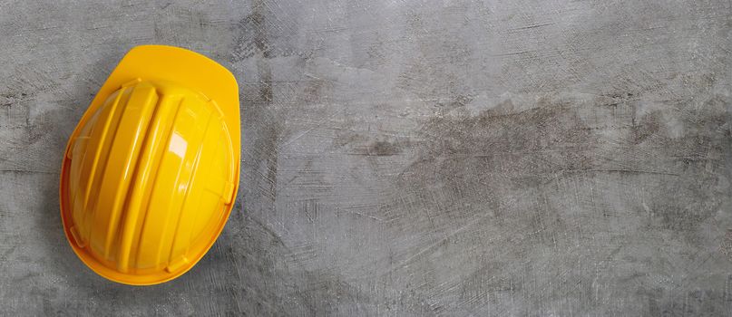 Construction helmet on concrete background. Copy space