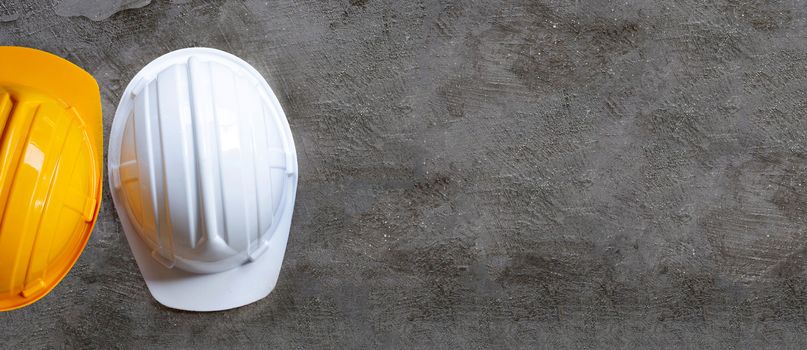 Construction helmets on concrete background. Copy space