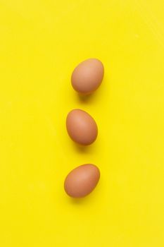 Eggs on yellow background. Top view