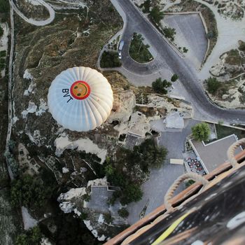 Goereme, Anatolia, Turkey, July 3rd 2015: View from above onto a balloon and the entrance of the Goereme open-air museum.