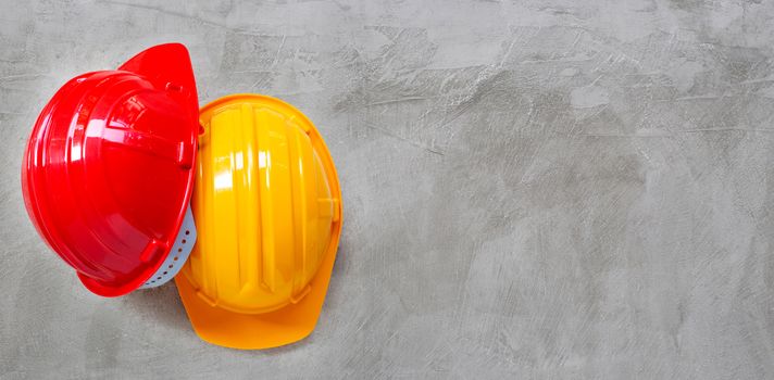 Construction helmets on concrete background. Top view