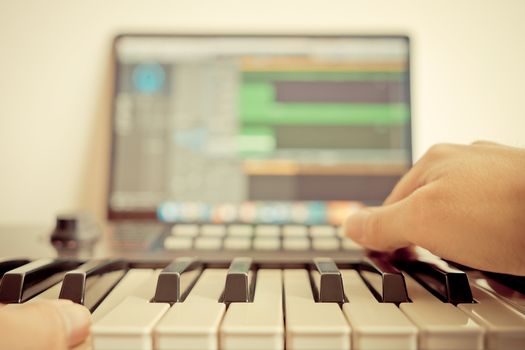 Music keyboard player is recording song on computer DAW music station