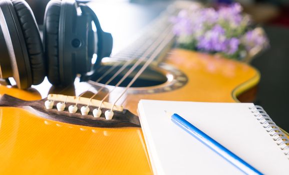 Songwriter with guitar notebook for songwriting concept