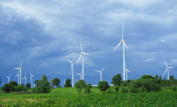 White wind turbine On the green mountains used to produce electricity.Clean energy concept. Concept of natural energy.landscape