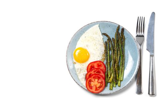 Healthy homemade breakfast with asparagus, fried egg and arugula. quarantine healthy eating concept. keto diet