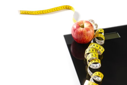 Diet plan, menu or program, tape measure, diet food of fresh fruits on white background, weight loss and detox concept, top view. weight loss concept. Apple and measuring tape. Diet